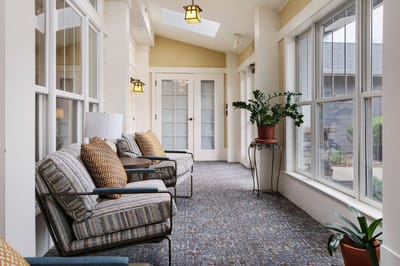 Well-decorated interior hallway with seating and plants