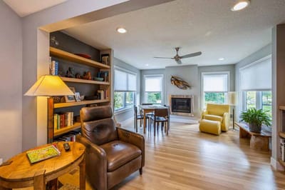 Bright common area with seating and a fireplace