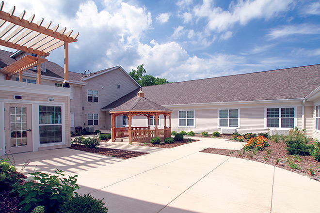Well-maintained outdoor courtyard with gazebo and gardens