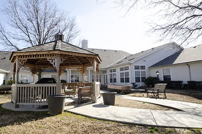 Outdoor gazebo area with seating and pathways