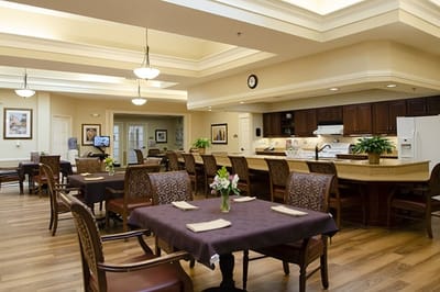 Bright dining room with tables set for residents