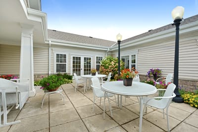 Outdoor patio area with tables and flowers