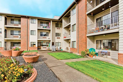 Outdoor view of a senior living facility with gardens