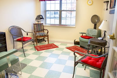 Hair salon area with seating and styling equipment
