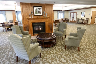Common area with chairs and a fireplace