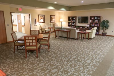 Common area with seating and a TV in the facility