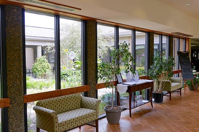 Bright common area with large windows and seating