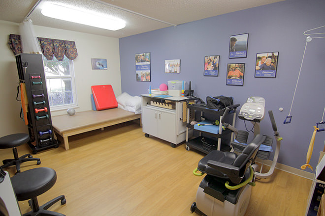 Interior view of a therapy room with exercise equipment