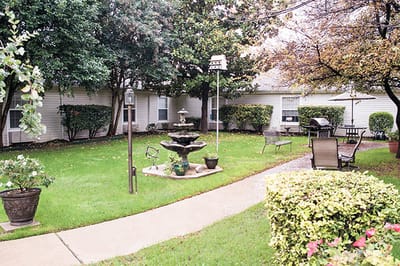 Well-maintained garden area with seating and a fountain
