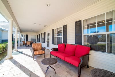 Outdoor seating area with red couches and tables