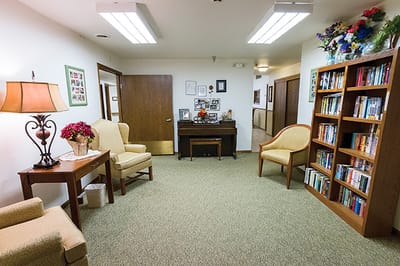 Cozy common area with seating and bookshelf
