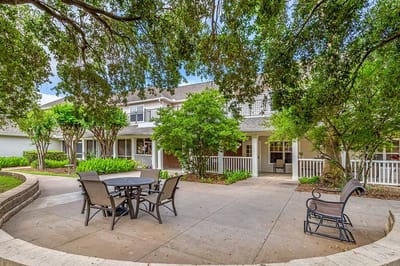 Outdoor seating area with tables amidst greenery