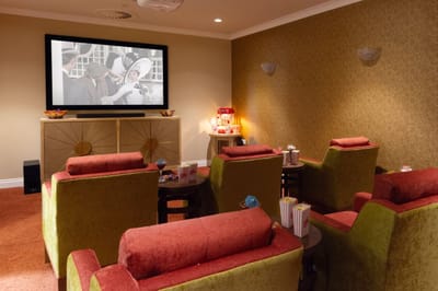 Cozy activity room with plush seating and a large TV