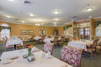 Dining area with tables set for residents
