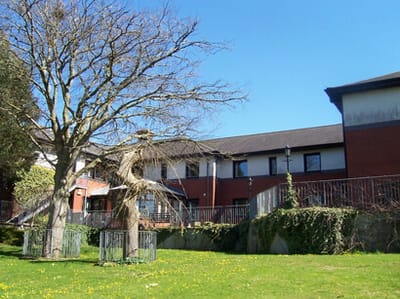 Exterior view of Butterfly Lodge with trees and grass