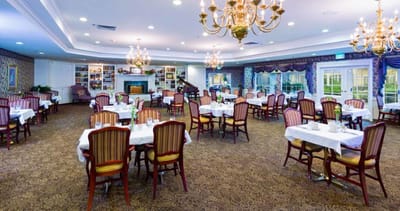 Dining room with tables and chairs set for meals