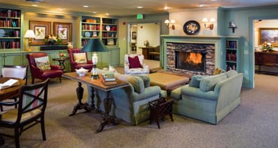 Cozy interior common area with fireplace and bookshelves