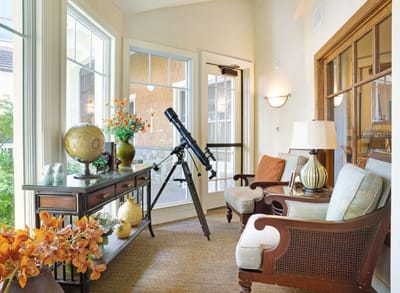 Bright common area with cozy seating and telescope