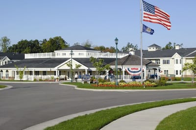 Exterior view of Castle Pointe at Baywinde with American flag