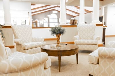 Cozy lounge area with upholstered chairs and a table