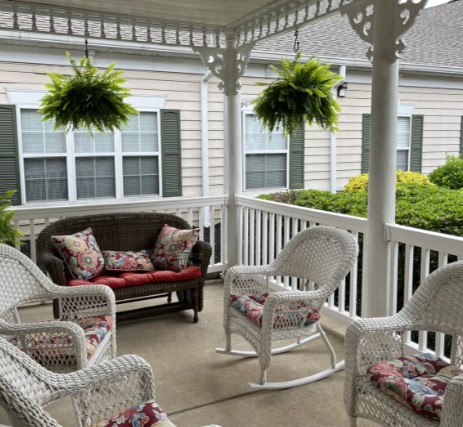 Outdoor seating area with wicker furniture and hanging plants
