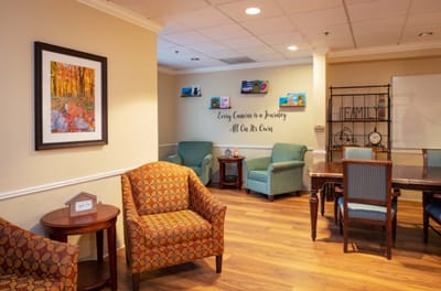 Comfortable common area with chairs and artwork