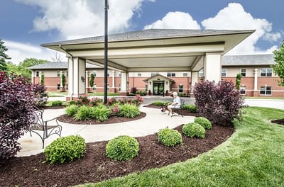 Exterior view of the facility with a resident and dog
