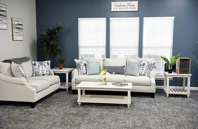 Bright and cozy common area seating with plants and decor