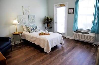 A cozy private resident room with bed and decor