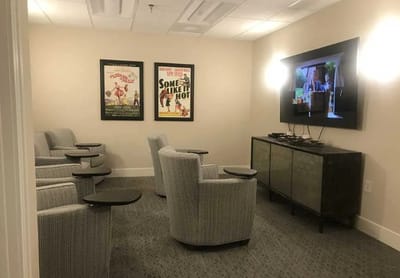 Cozy indoor activity room with movie seating
