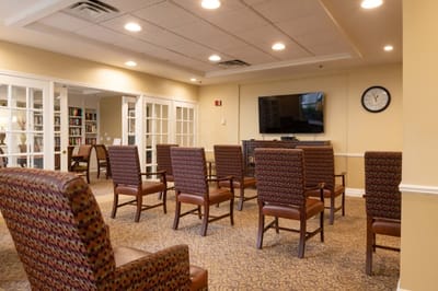 Bright common area with chairs and a TV