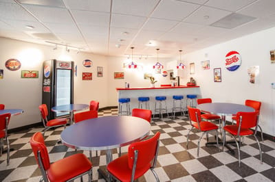 Bright dining area with red chairs and retro decor