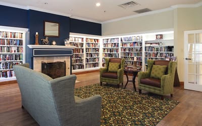 Cozy library area with bookshelves and seating
