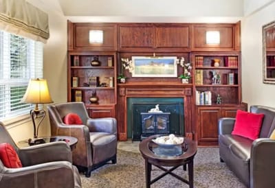 Interior lounge area with comfortable seating and bookshelves