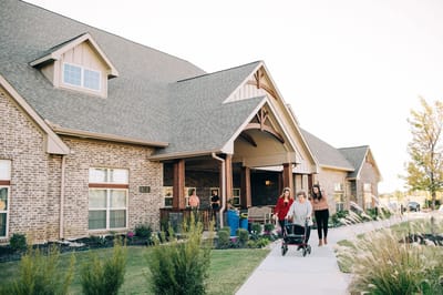 Residents walking outside the assisted living facility