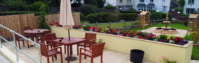 Outdoor garden area with seating and flowers