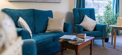 Bright common area with blue upholstered furniture