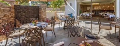 Outdoor dining area with tables and chairs