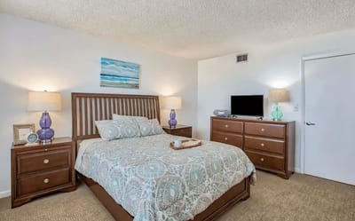 Cozy bedroom interior with a queen bed and chest of drawers
