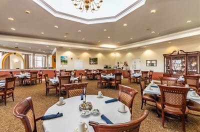 Dining area with well-set tables and a chandelier
