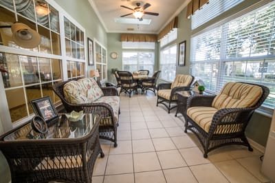 Bright common area with wicker furniture and windows
