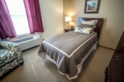 Cozy resident room with bed and seating area