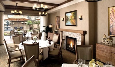 Elegant dining room setup with tables and fireplace