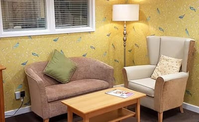Cozy living room area with comfortable seating and lamp