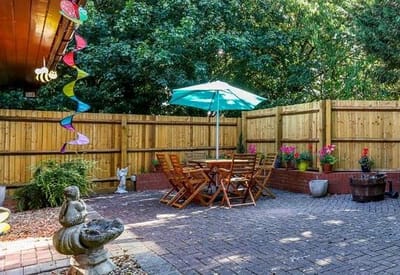 Cozy outdoor seating area with sunlight and greenery