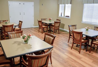 Bright dining room with tables and floral arrangements
