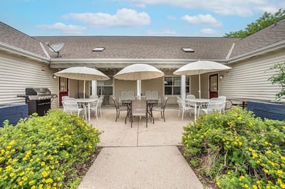 Outdoor seating area with tables and umbrellas