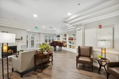 Bright common area with seating and piano