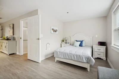 A private resident room with a bed and light decor