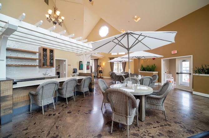 Bright dining room with umbrellas and wicker chairs